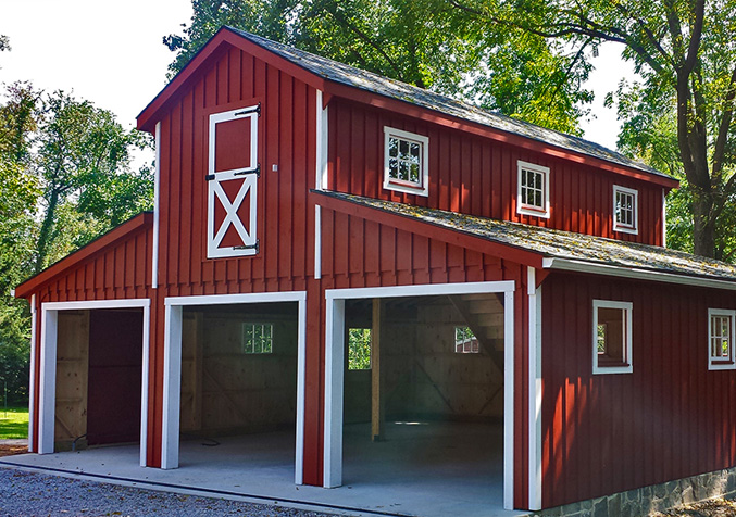 empty red barn with white accents and multiple doors