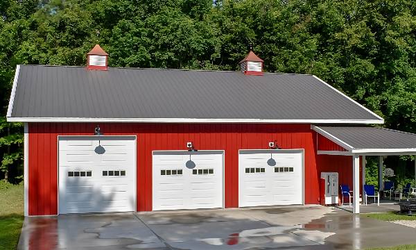 white barn with a gas station in front