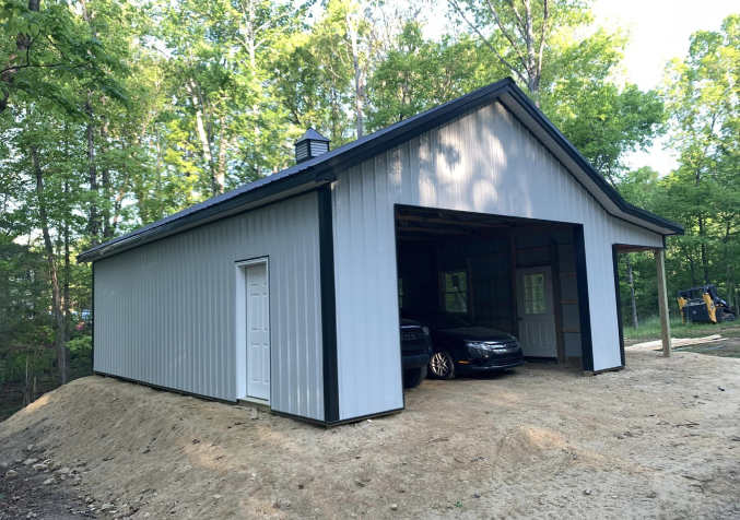 white barn, blue roof with overhead protecting a speedboat under it